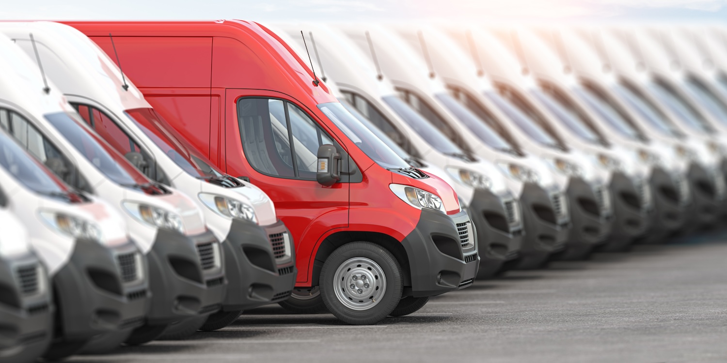 Finor Finance Red delivery van in a row among white vans