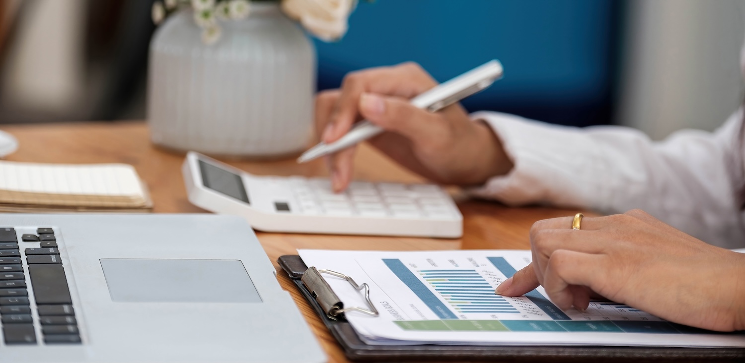 Finor Finance Accountant using a calculator to calculate the numbers